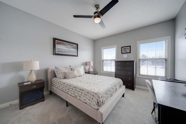 bedroom with ceiling fan and light carpet