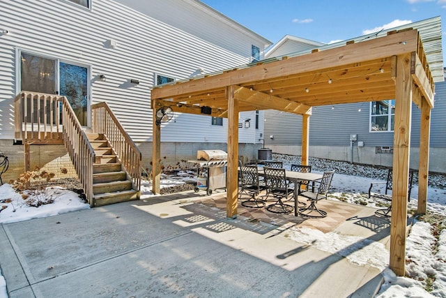 snow covered patio with grilling area