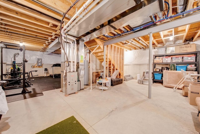 basement featuring electric panel and heating unit