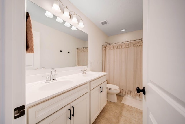 bathroom featuring vanity, toilet, and walk in shower