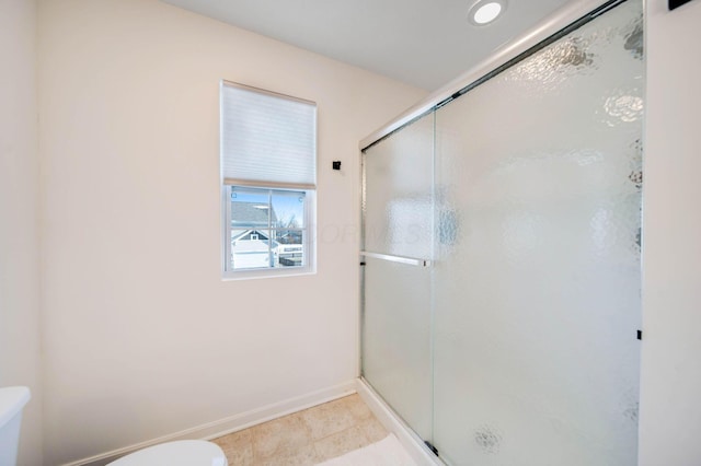 bathroom featuring toilet and an enclosed shower