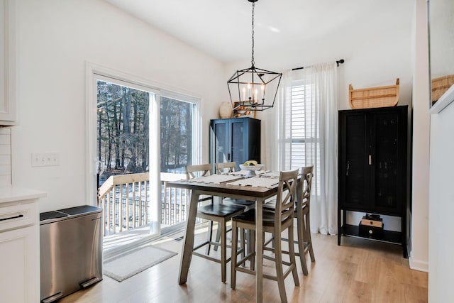 dining room with a notable chandelier and light hardwood / wood-style floors