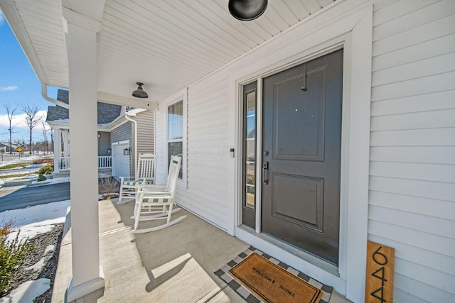 view of exterior entry featuring a porch