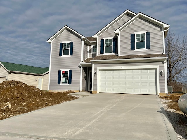 view of front of property featuring cooling unit and a garage