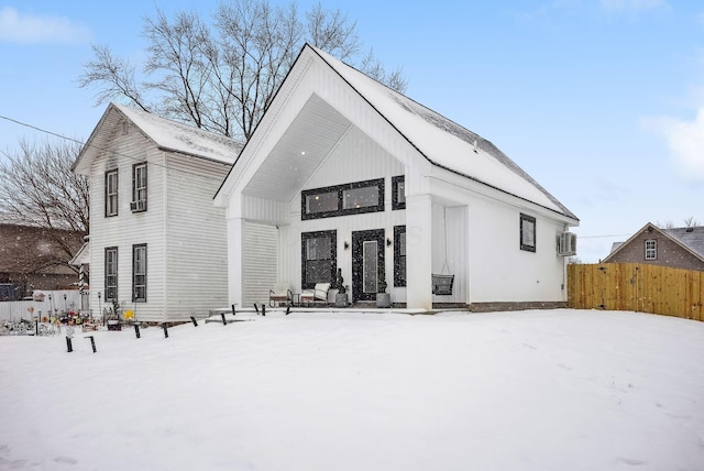 view of snow covered rear of property