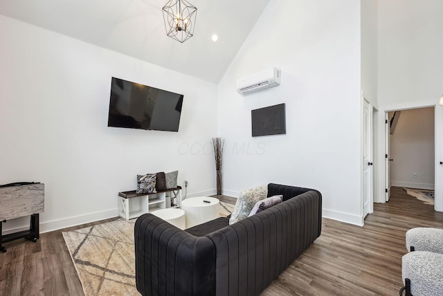 living room featuring high vaulted ceiling, a wall mounted AC, an inviting chandelier, and hardwood / wood-style floors