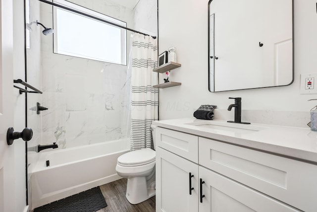 full bathroom featuring toilet, hardwood / wood-style floors, vanity, and shower / bathtub combination with curtain