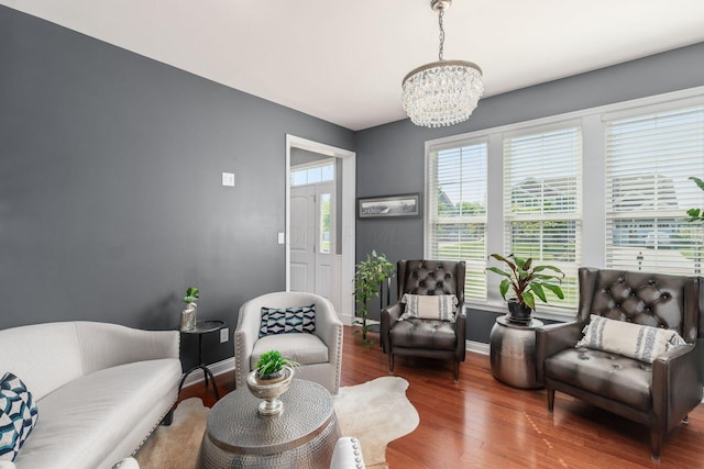 sitting room featuring hardwood / wood-style flooring and an inviting chandelier