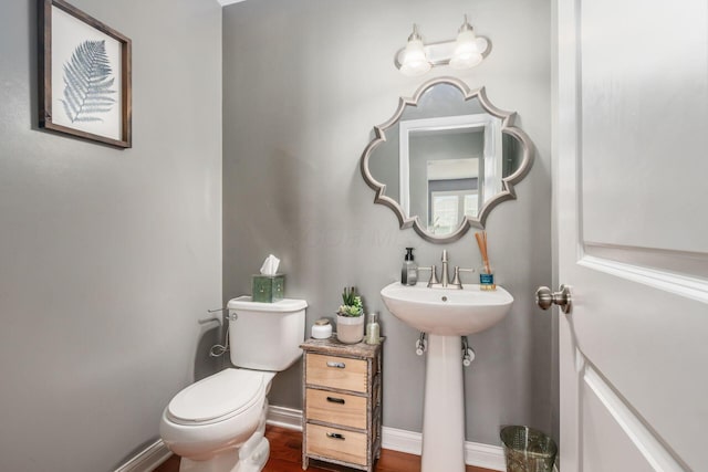 bathroom featuring hardwood / wood-style floors and toilet