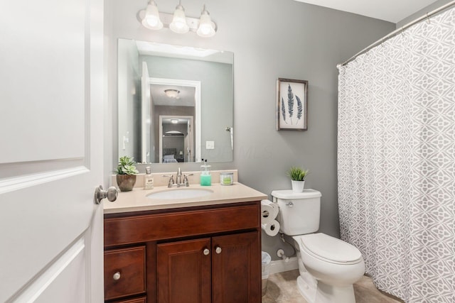 bathroom with tile patterned flooring, vanity, and toilet