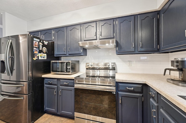 kitchen featuring decorative backsplash, light hardwood / wood-style floors, a textured ceiling, and appliances with stainless steel finishes