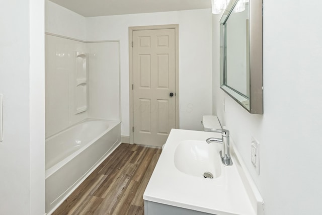 full bathroom featuring vanity, wood-type flooring, bathtub / shower combination, and toilet