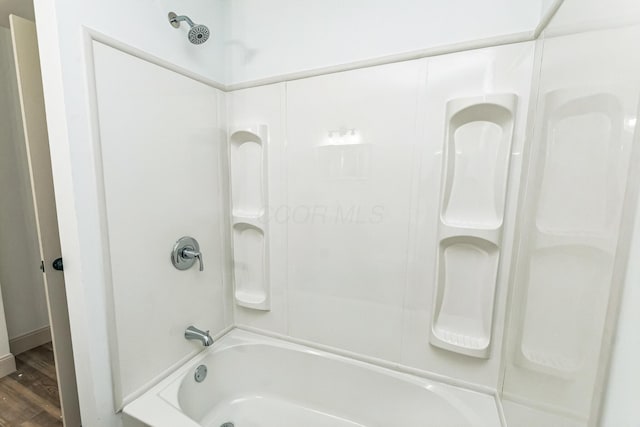 bathroom with shower / tub combination and hardwood / wood-style flooring