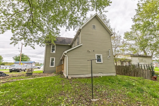 back of house featuring a yard