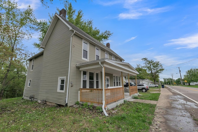 view of side of home with covered porch