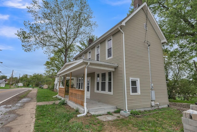 view of property exterior featuring covered porch