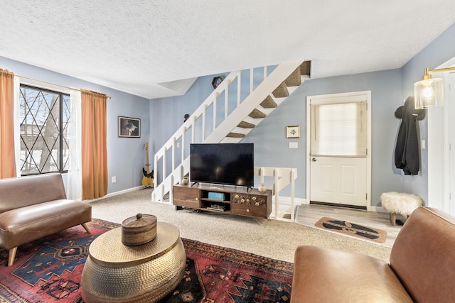 carpeted living room featuring a textured ceiling