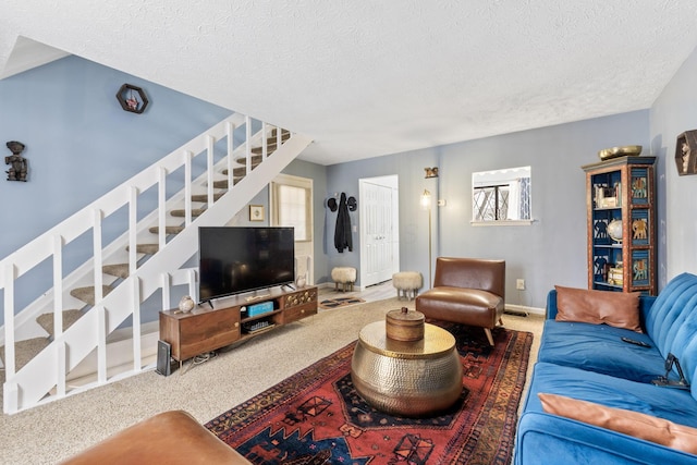 living room featuring carpet floors and a textured ceiling