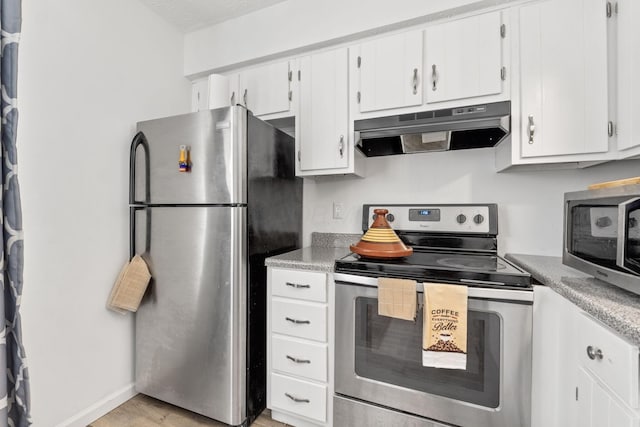 kitchen with light hardwood / wood-style floors, white cabinetry, and stainless steel appliances