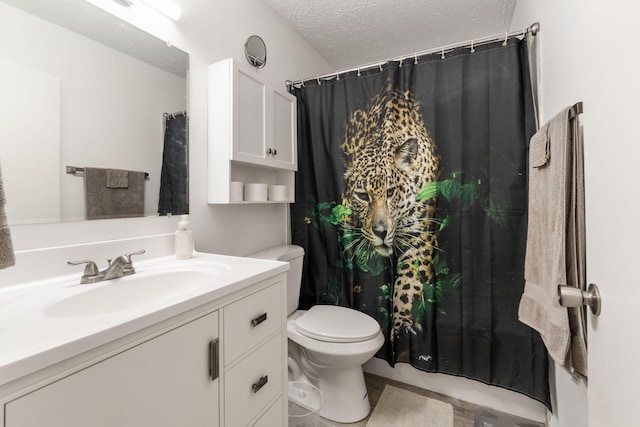 bathroom with vanity, a textured ceiling, toilet, and curtained shower