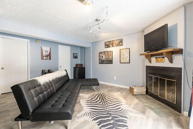 living room with a textured ceiling and light hardwood / wood-style flooring