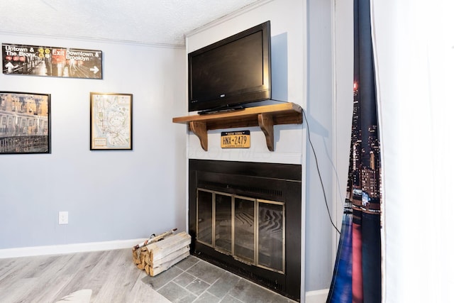 room details featuring hardwood / wood-style flooring, ornamental molding, and a textured ceiling