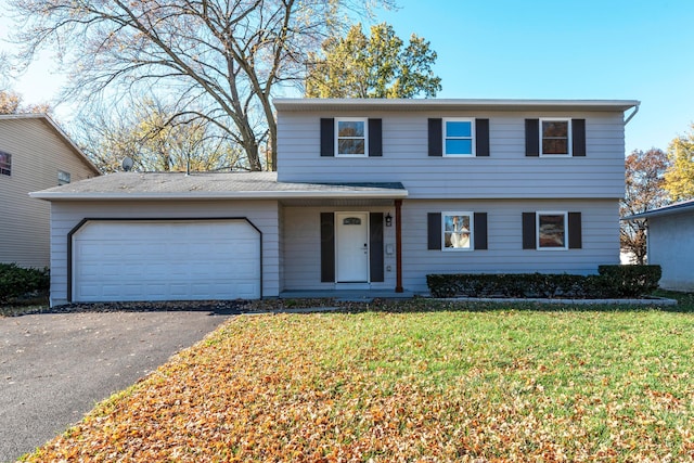 view of front property featuring a front yard and a garage