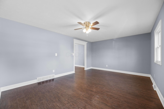 unfurnished room featuring ceiling fan and dark hardwood / wood-style flooring