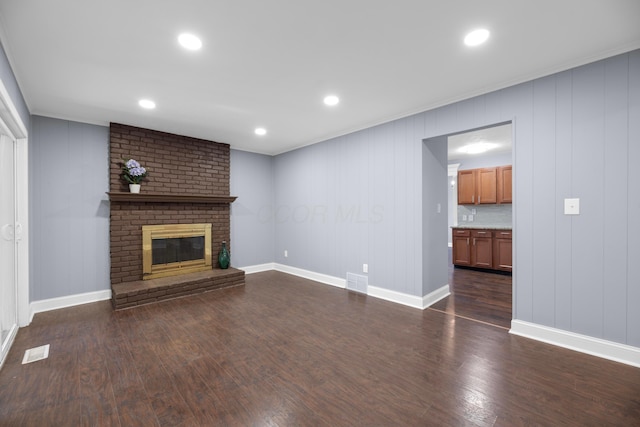 unfurnished living room featuring dark hardwood / wood-style floors and a fireplace