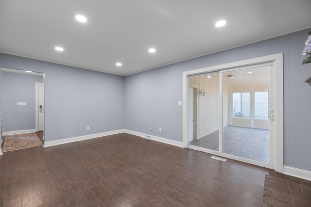 unfurnished room with dark hardwood / wood-style flooring