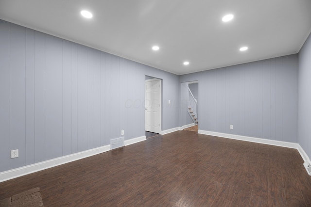 unfurnished room with dark hardwood / wood-style flooring