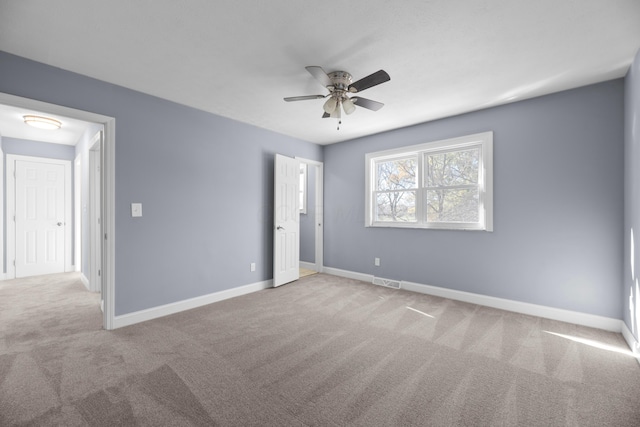 unfurnished bedroom with ceiling fan and light carpet