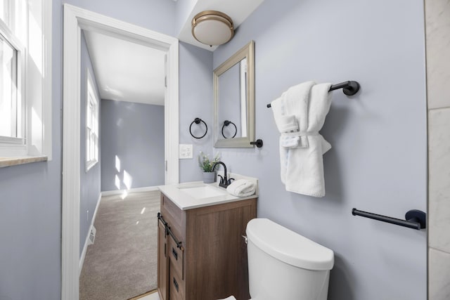 bathroom featuring vanity and toilet