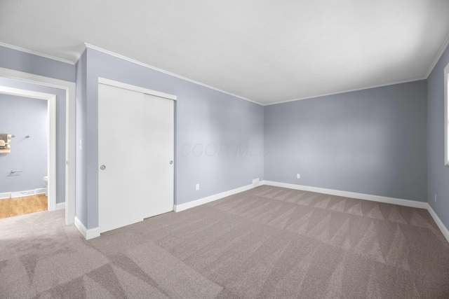 carpeted spare room with crown molding