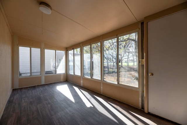 unfurnished sunroom featuring vaulted ceiling