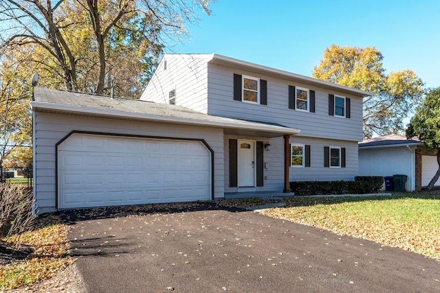 view of front facade featuring a front yard and a garage