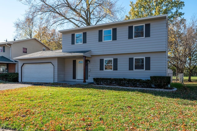 view of front property featuring a front yard and a garage