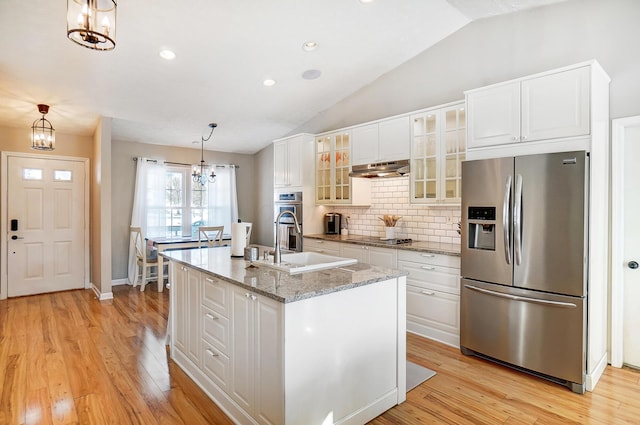 kitchen featuring white cabinetry, an island with sink, pendant lighting, and appliances with stainless steel finishes