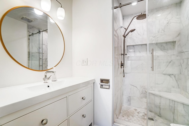 bathroom featuring vanity and a shower with shower door