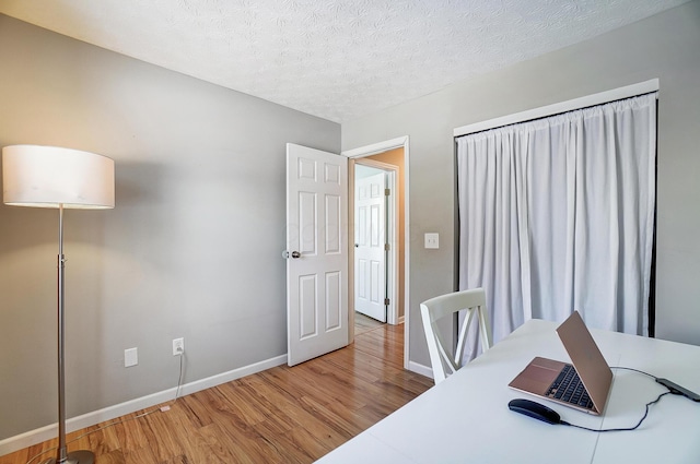 office space featuring hardwood / wood-style flooring and a textured ceiling