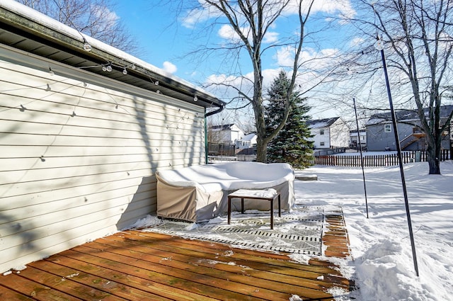 snow covered deck with a grill