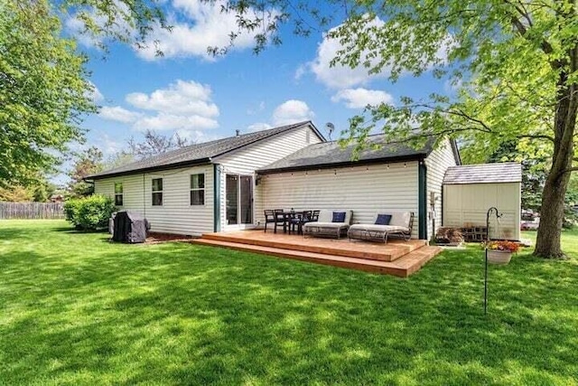 back of property featuring a lawn and a wooden deck