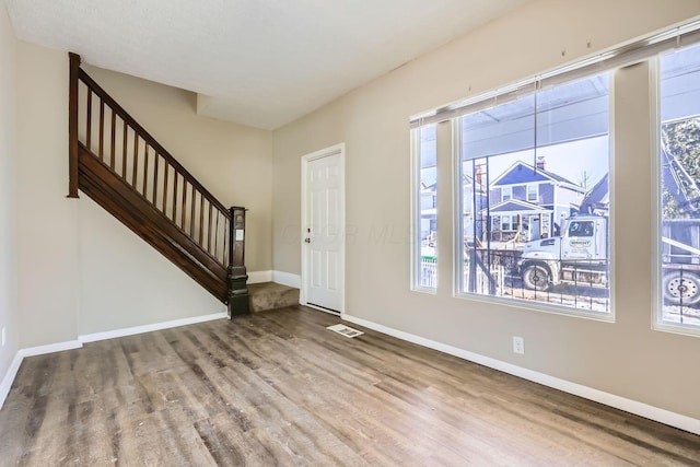 entrance foyer featuring wood-type flooring and plenty of natural light