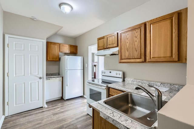 kitchen featuring white appliances, sink, and light hardwood / wood-style flooring