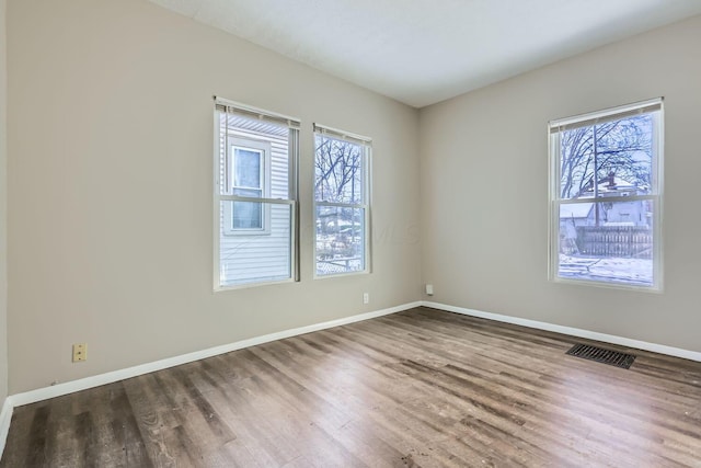 spare room with dark hardwood / wood-style floors