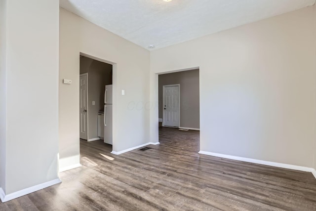 unfurnished room with dark hardwood / wood-style floors