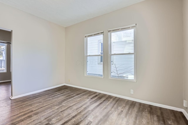 empty room featuring dark hardwood / wood-style flooring