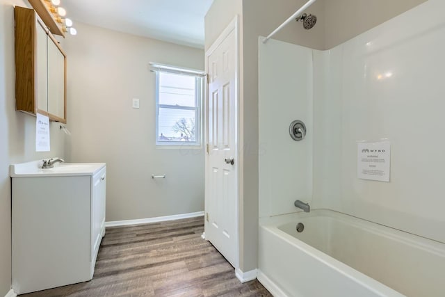 bathroom featuring hardwood / wood-style flooring, vanity, and bathtub / shower combination