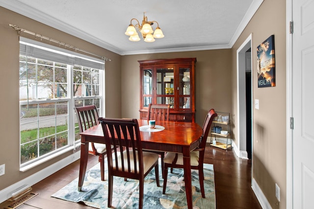 dining space featuring a chandelier, wood-type flooring, and ornamental molding