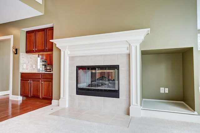 interior details with hardwood / wood-style flooring, stainless steel oven, a fireplace, and tasteful backsplash